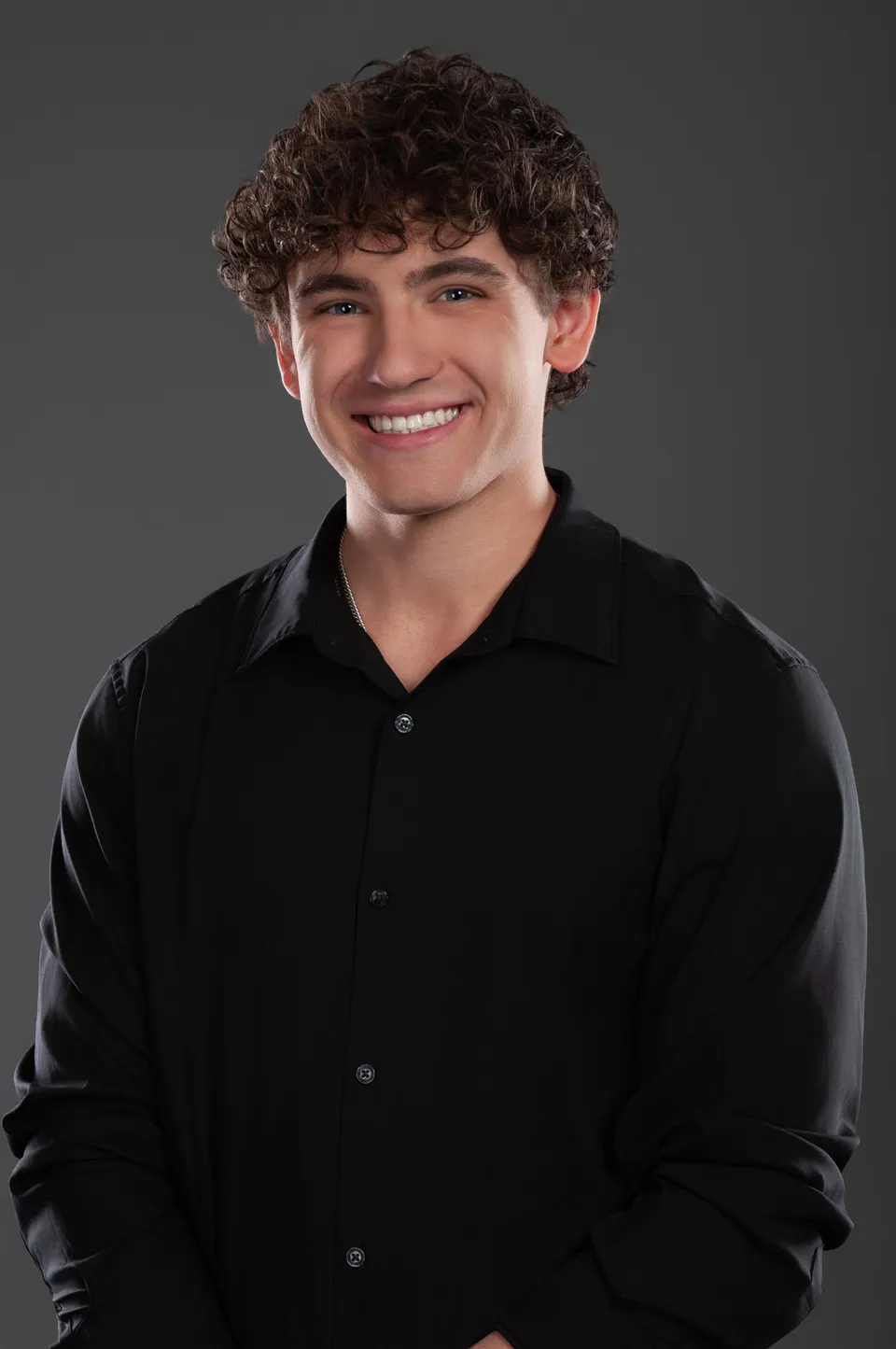 Jax Kemper smiling in a black shirt